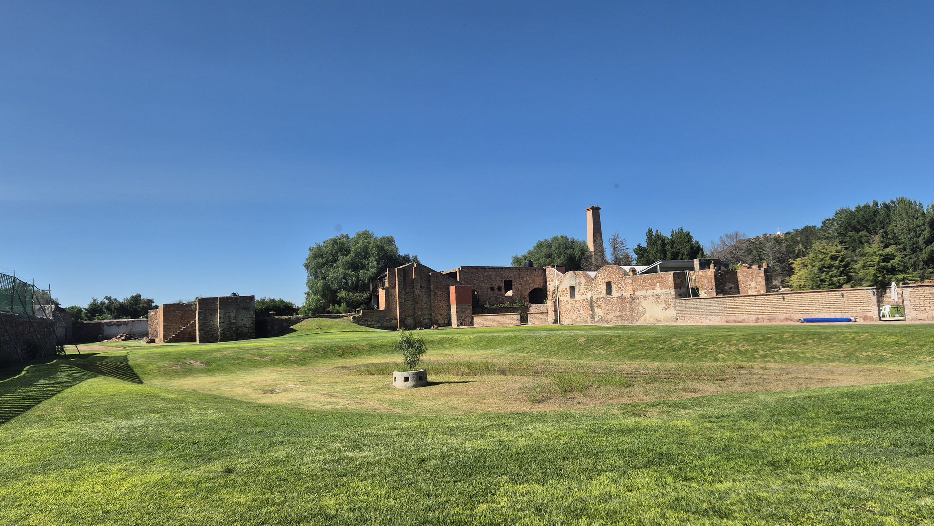 Jardín Lago con vistas al casco de la antigua fábrica de mezcal en Hacienda Cerro Prieto